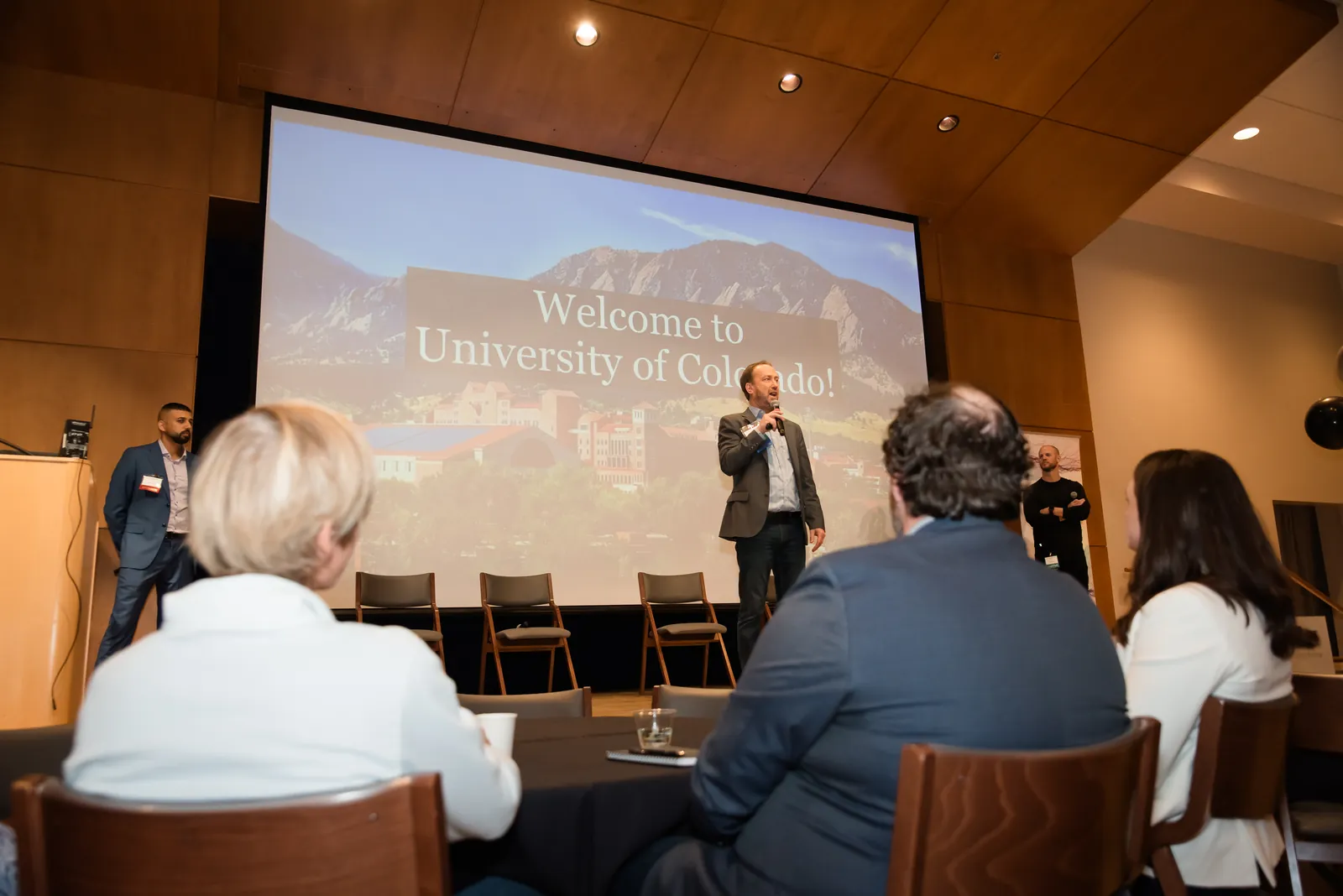 A speaker welcoming attendees at the University of Colorado Boulder