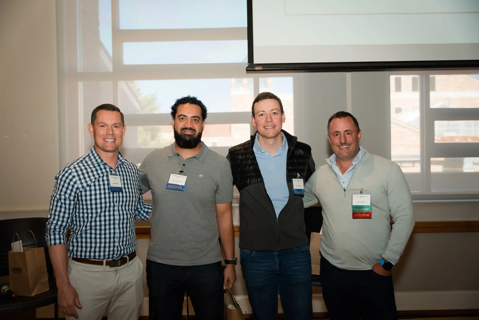 Four attendees standing together and talking after a session