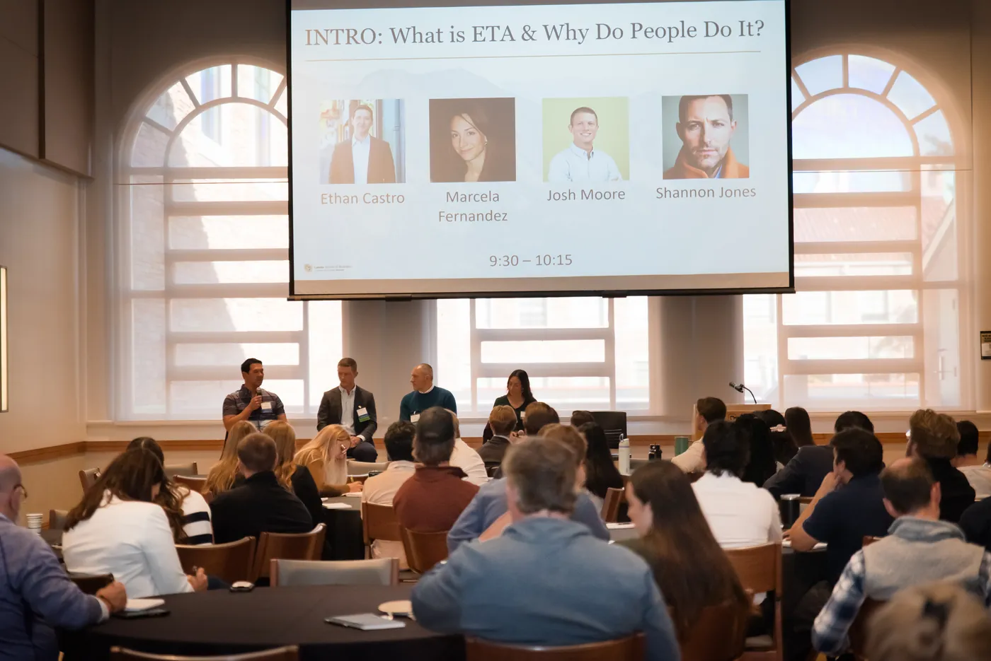 Attendees watching a session titled Intro: What is ETA and why do people do it