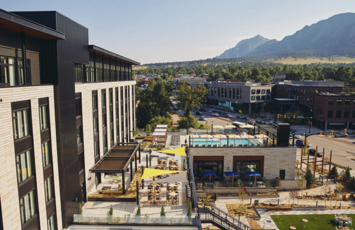 Limelight Boulder terrace and pool with the Flatirons rising behind the hotel