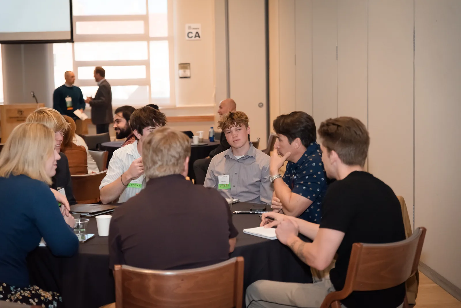 RMETA attendees working through a problem in a small group